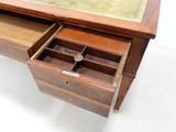 a wooden desk with a glass top and drawers