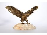 an image of a statue of an eagle on a rock
