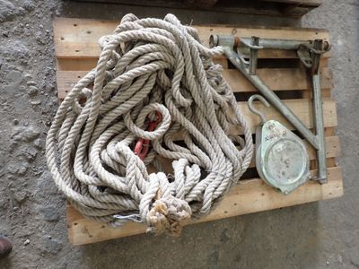 a pile of rope sitting on a pallet next to a pair of scissors