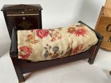 a small bench with a cushion on it next to a box