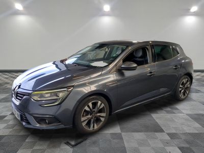 the grey car is parked on a checkered floor in the garage