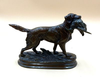 bronze statue of a dog with a bird in its mouth