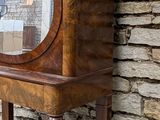 a small wooden cabinet with a mirror on top of it