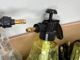 many different types of spray guns on a shelf