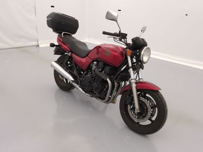 a red motorcycle that is parked in a room