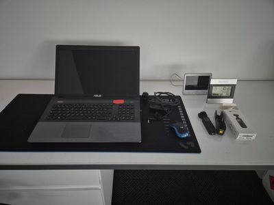 a laptop computer sitting on top of a white desk