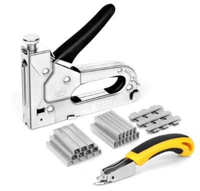 a stapler, cutter, and other tools on a white background
