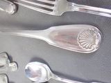 a lot of silver spoons and spoon spoons on a table