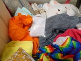 a box full of clothes and stuffed animals inside of it