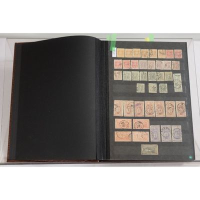 an open book with stamps on it sitting on top of a table