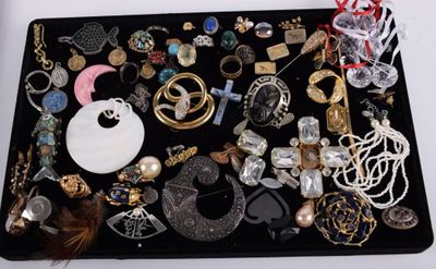 a black tray filled with assorted jewelry on a table