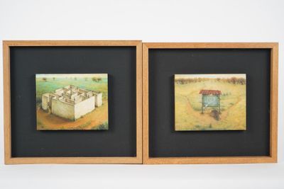 two framed pictures of sheep in a field with a barn in the background