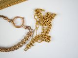 a picture of a gold chain with a ring on it
