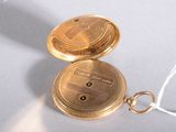an image of a gold pocket watch on a white surface