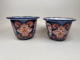 two blue and orange bowls with designs on them sitting on a table