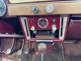 a dashboard of a car with many gauges and controls