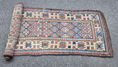 rug on the ground with a roll of fabric on it