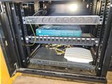 a rack with a bunch of electronic equipment inside of it