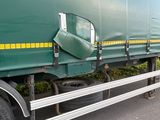 a large green truck with a yellow stripe on the side of it