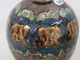 a brown vase with a blue and brown design on it