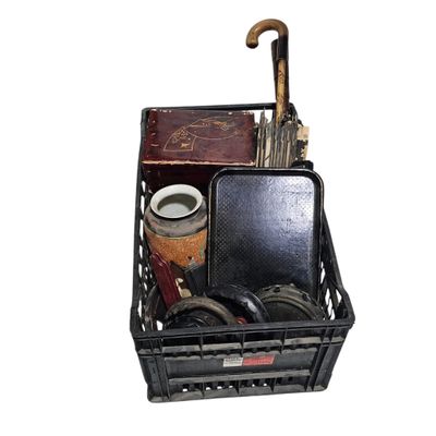 a black basket with a umbrella and other items in it