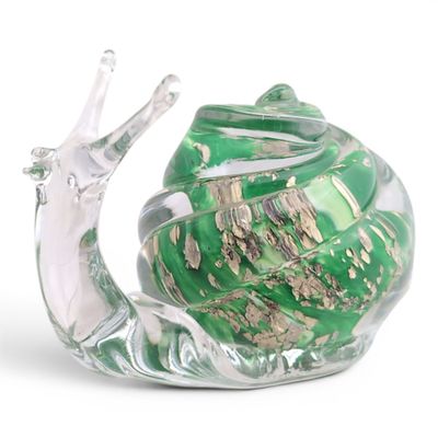 a glass snail that is sitting on top of a glass bowl