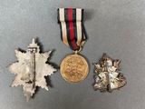 three medals and a medal are sitting on a table