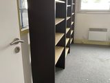a room with shelves and a door in it