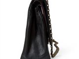 the small black purse is sitting on a white surface