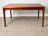 an image of a wooden table on a carpeted floor