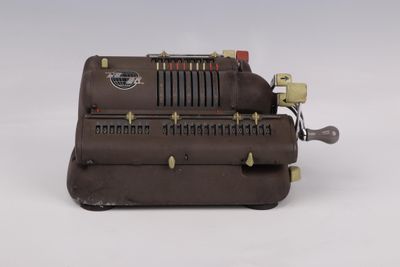 a brown machine that is sitting on a white surface