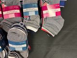 six pairs of gray and blue socks are on a black surface