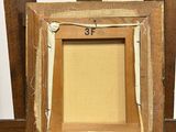 an old wooden easel with a picture frame on top of it