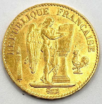 a close up of a gold coin on a white surface