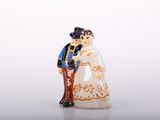 a figurine of a man and a woman standing next to each other