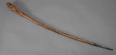 a close up of a wooden sword on a gray surface