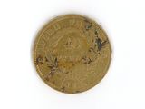 a gold coin on a white surface with a white background