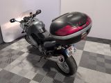 a motorcycle parked in a room with a checkered floor