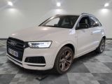 the white audi q3 is parked on a checkered floor