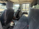 the interior of a van with two black seats and a black seat belt