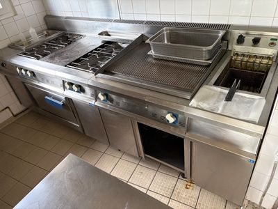 une cuisine équipée d'une cuisinière, d'un four et d'un évier