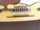 a painting of a guitar with a sheet of music on it