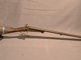 an old rifle with a wooden barrel and a wooden handle