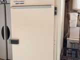 a white refrigerator and a white refrigerator freezer in a room