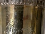 a silver vase with a name engraved on it