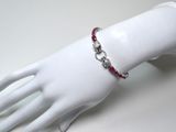 silver bracelet with red stones on a mannequin hand