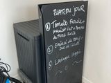 un tableau noir sur lequel sont écrits des mots, à côté d'un vélo