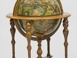 an old globe on a stand with a wooden base