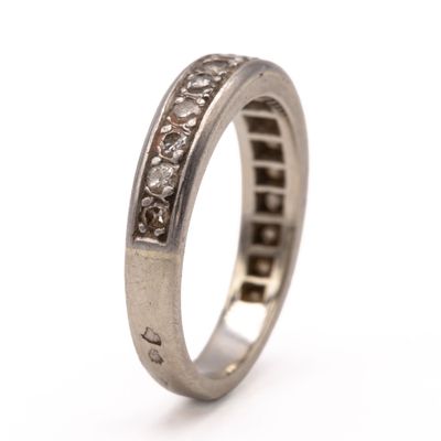 a close up of a wedding ring with diamonds on it
