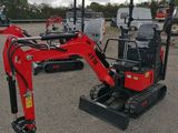 a small red excavator that is parked in the dirt